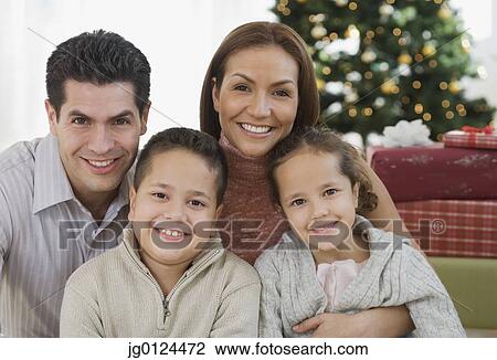 Stock Image - Portrait of Hispanic family on Christmas. Fotosearch