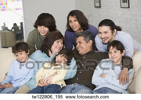 Stock Photography - Portrait of Hispanic family on sofa. Fotosearch