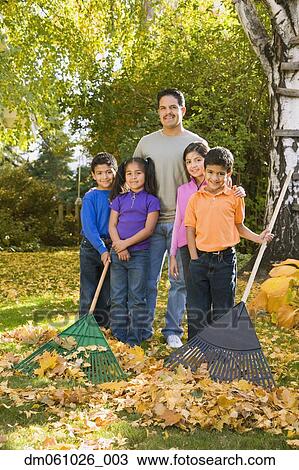 Portrait of Hispanic family raking leaves View Large Photo Image Stock Image - Portrait of Hispanic family raking leaves. Fotosearch