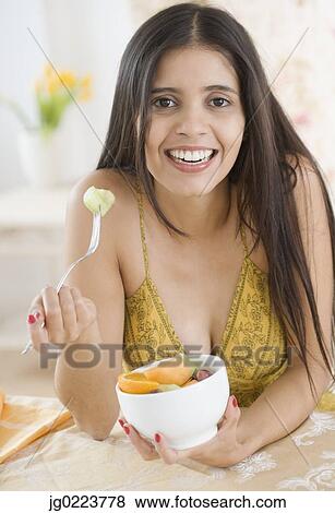 Portrait of Hispanic woman eating fruit salad View Large Photo Image Stock Photo - Portrait of Hispanic woman eating fruit salad. Fotosearch