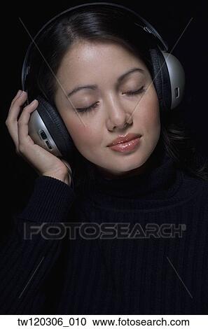 Portrait of Hispanic woman wearing headphones View Large Photo Image Stock Image - Portrait of Hispanic woman wearing headphones. Fotosearch