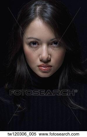Stock Photography - Portrait of Hispanic woman wearing sweater. Fotosearch