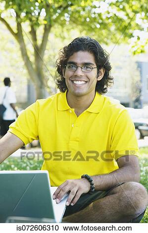 Portrait of Indian male college student in grass View Large Photo Image Stock Image - Portrait of Indian male college student in grass. Fotosearch