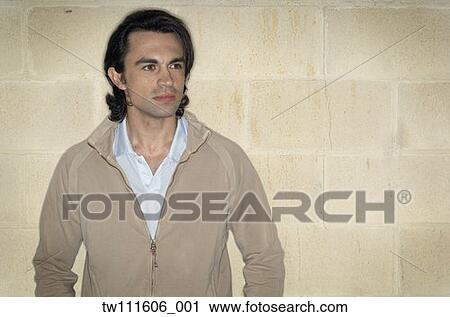 Portrait of man leaning against wall View Large Photo Image Stock Image - Portrait of man leaning against wall. Fotosearch