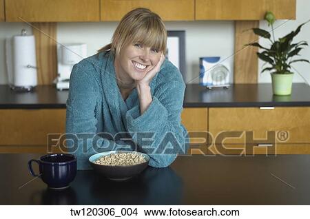 Portrait of woman sitting at breakfast table View Large Photo Image Picture - Portrait of woman sitting at breakfast table. Fotosearch
