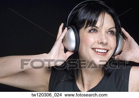 Portrait of woman wearing headphones View Large Photo Image Picture - Portrait of woman wearing headphones. Fotosearch