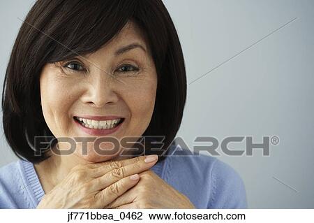 Senior Asian woman resting chin on hands View Large Photo Image Stock Image - Senior Asian woman resting chin on hands. Fotosearch