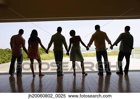 Silhouette of friends holding hands at beach resort View Large Photo Image Stock Photography - Silhouette of friends holding hands at beach resort. Fotosearch