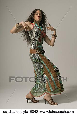 Stock Image - Studio shot of Asian woman dancing. Fotosearch