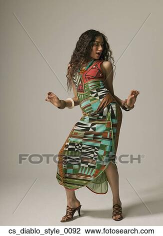 Stock Image - Studio shot of Asian woman dancing. Fotosearch