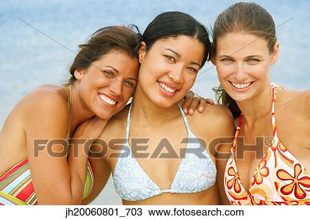 Three young women at beach View Large Photo Image Stock Image - Three young women at beach. Fotosearch