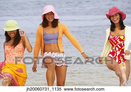 Three young women at beach View Large Photo Image Stock Photography - Three young women at beach. Fotosearch