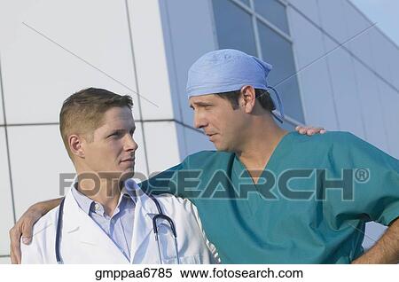 Two male doctors looking at each other View Large Photo Image Stock Photography - Two male doctors looking at each other. Fotosearch