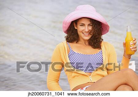 Woman drinking at beach View Large Photo Image Stock Image - Woman drinking at beach. Fotosearch