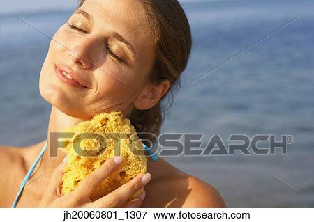 Woman holding natural sponge View Large Photo Image Stock Photo - Woman holding natural sponge. Fotosearch