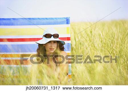 Woman sitting in field View Large Photo Image Stock Photo - Woman sitting in field. Fotosearch