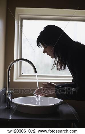 Woman washing hands in sink View Large Photo Image Stock Image - Woman washing hands in sink. Fotosearch