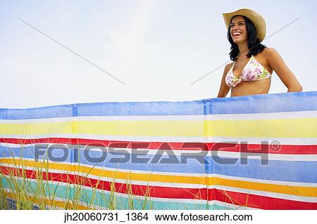 Woman wearing bikini top and straw hat View Large Photo Image Picture - Woman wearing bikini top and straw hat. Fotosearch