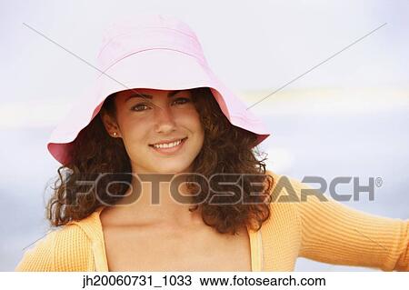 Woman wearing hat at beach View Large Photo Image Stock Image - Woman wearing hat at beach. Fotosearch