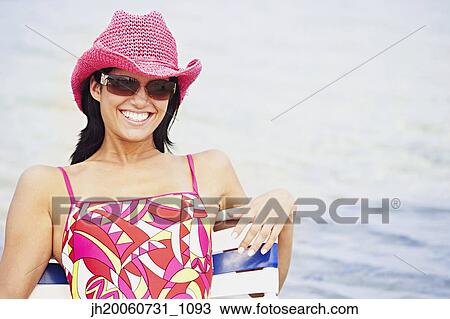 Woman wearing hat at beach View Large Photo Image Stock Image - Woman wearing hat at beach. Fotosearch