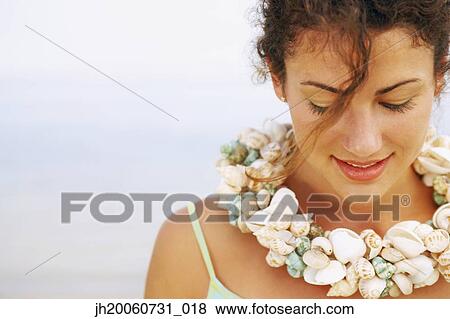 Woman wearing seashell necklace View Large Photo Image Stock Photo - Woman wearing seashell necklace. Fotosearch