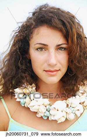 Stock Photo - Woman wearing seashell necklace. Fotosearch