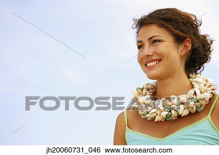 Woman wearing seashell necklace View Large Photo Image Stock Photograph - Woman wearing seashell necklace. Fotosearch