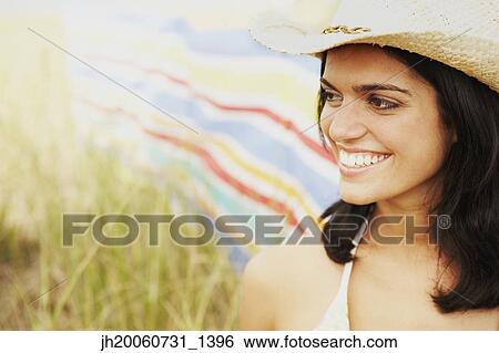 Woman wearing straw hat in field View Large Photo Image Stock Photograph - Woman wearing straw hat in field. Fotosearch