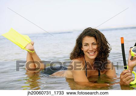 Woman with snorkel gear in water View Large Photo Image Stock Image - Woman with snorkel gear in water. Fotosearch