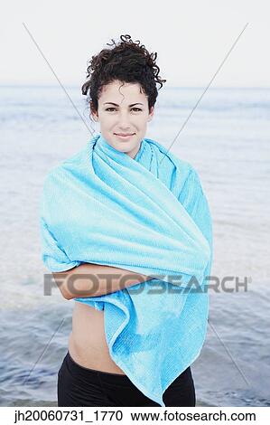 Woman wrapped in towel at beach View Large Photo Image Stock Image - Woman wrapped in towel at beach. Fotosearch