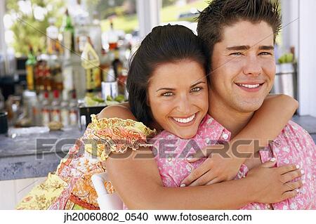 Young couple hugging at bar View Large Photo Image Stock Image - Young couple hugging at bar. Fotosearch