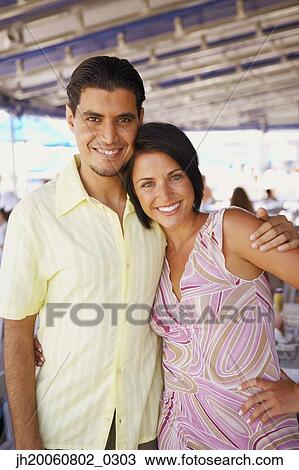 Young couple hugging outdoors View Large Photo Image Stock Image - Young couple hugging outdoors. Fotosearch