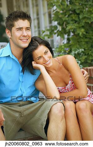 Young couple hugging outdoors View Large Photo Image Stock Image - Young couple hugging outdoors. Fotosearch