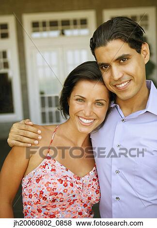 Young couple hugging outdoors View Large Photo Image Stock Photo - Young couple hugging outdoors. Fotosearch