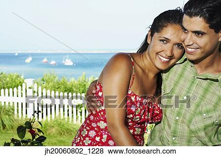 Young couple hugging outdoors View Large Photo Image Stock Photo - Young couple hugging outdoors. Fotosearch
