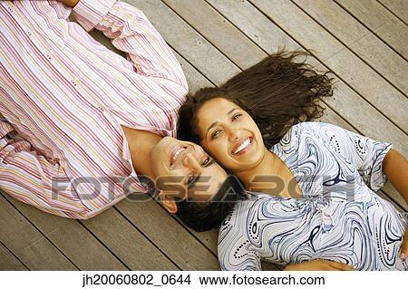 Young couple laying on deck View Large Photo Image Picture - Young couple laying on deck. Fotosearch