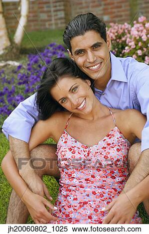 Young couple sitting in grass View Large Photo Image Stock Photography - Young couple sitting in grass. Fotosearch