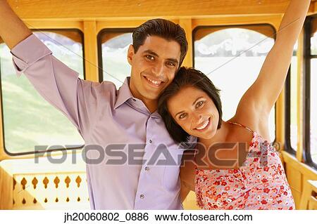 Young couple standing on trolley car View Large Photo Image Stock Photograph - Young couple standing on trolley car. Fotosearch