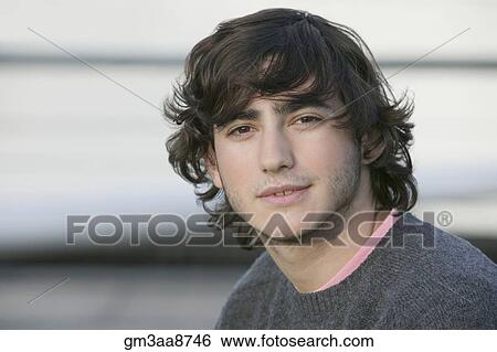Stock Photograph - Young Hispanic man wearing sweater. Fotosearch