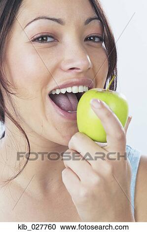 Young woman eating apple View Large Photo Image Stock Image - Young woman eating apple. Fotosearch