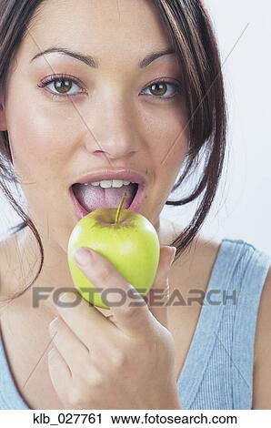 Young woman eating apple View Large Photo Image Stock Image - Young woman eating apple. Fotosearch