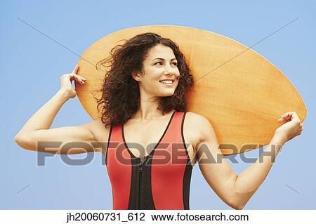 Young woman holding boogie board View Large Photo Image Stock Image - Young woman holding boogie board. Fotosearch