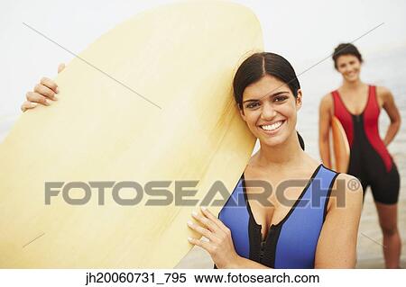 Young woman holding boogie board View Large Photo Image Stock Photography - Young woman holding boogie board. Fotosearch
