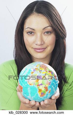 Young woman holding globe View Large Photo Image Stock Image - Young woman holding globe. Fotosearch