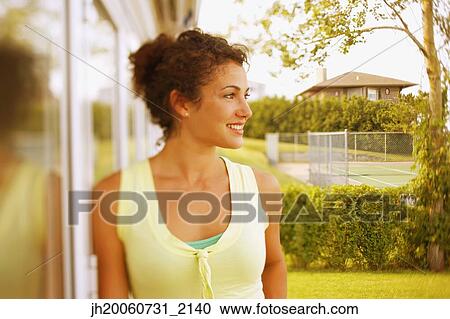 Young woman leaning against glass door View Large Photo Image Stock Image - Young woman leaning against glass door. Fotosearch