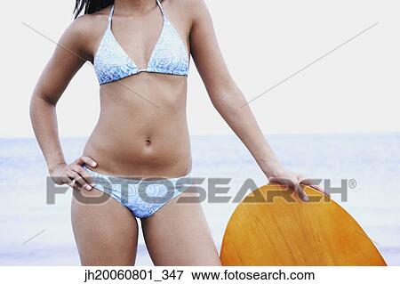 Young woman leaning on boogie board View Large Photo Image Stock Photo - Young woman leaning on boogie board. Fotosearch