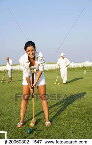 Young woman playing croquet View Large Photo Image Stock Photo - Young woman playing croquet. Fotosearch