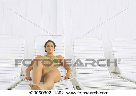 Young woman sunbathing View Large Photo Image Stock Image - Young woman sunbathing. Fotosearch