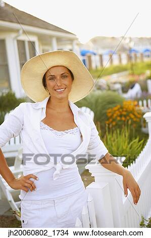 Young woman wearing sun hat View Large Photo Image Picture - Young woman wearing sun hat. Fotosearch