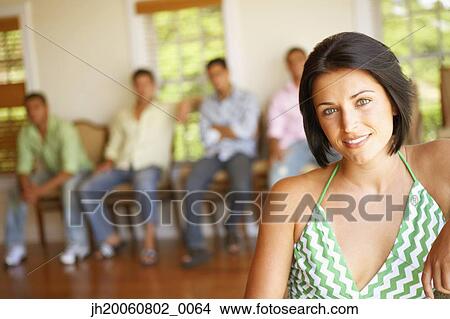 Picture - Young woman with friends in background. Fotosearch